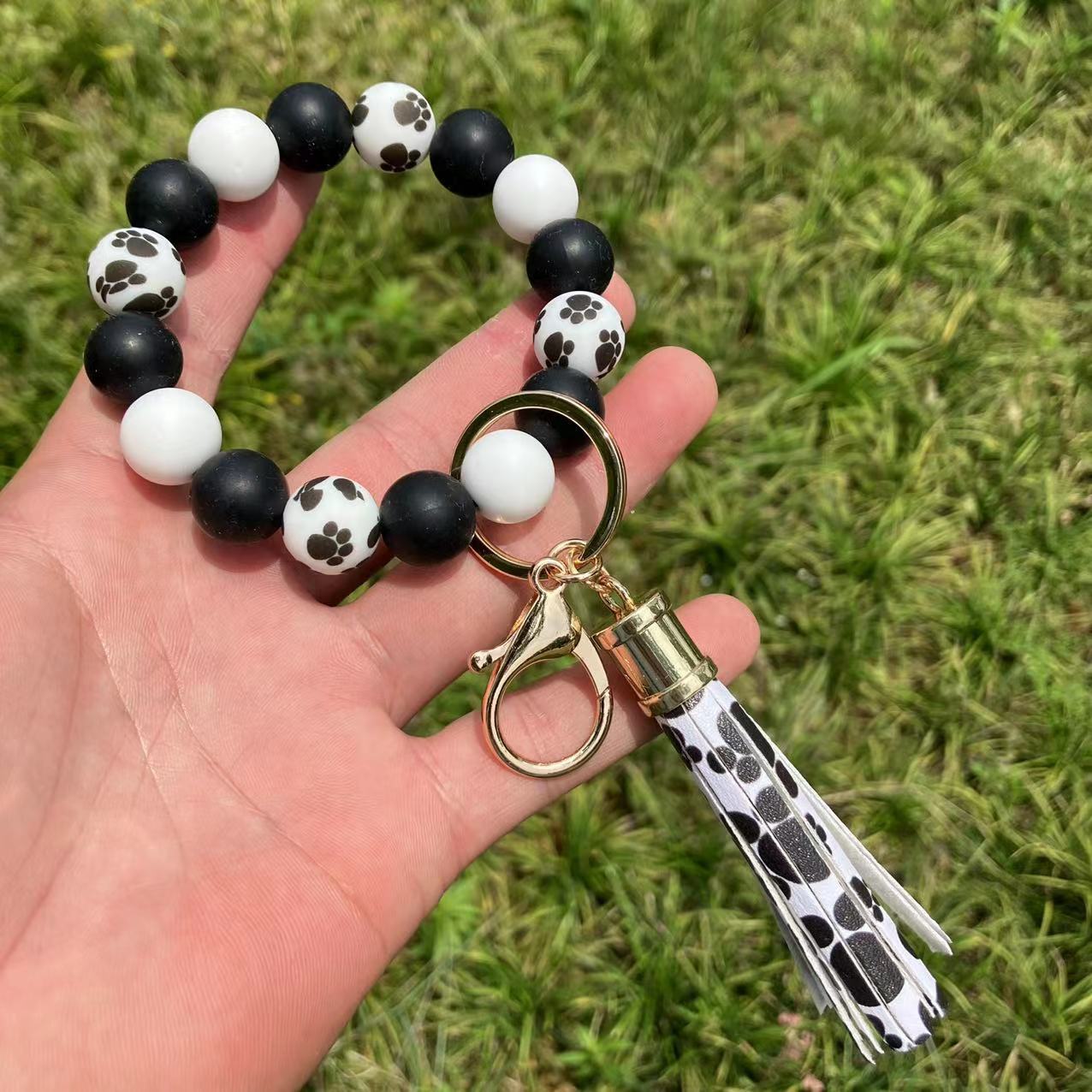 Comercio al por mayor leopardo girasol borla de silicona con cuentas llavero de muñeca